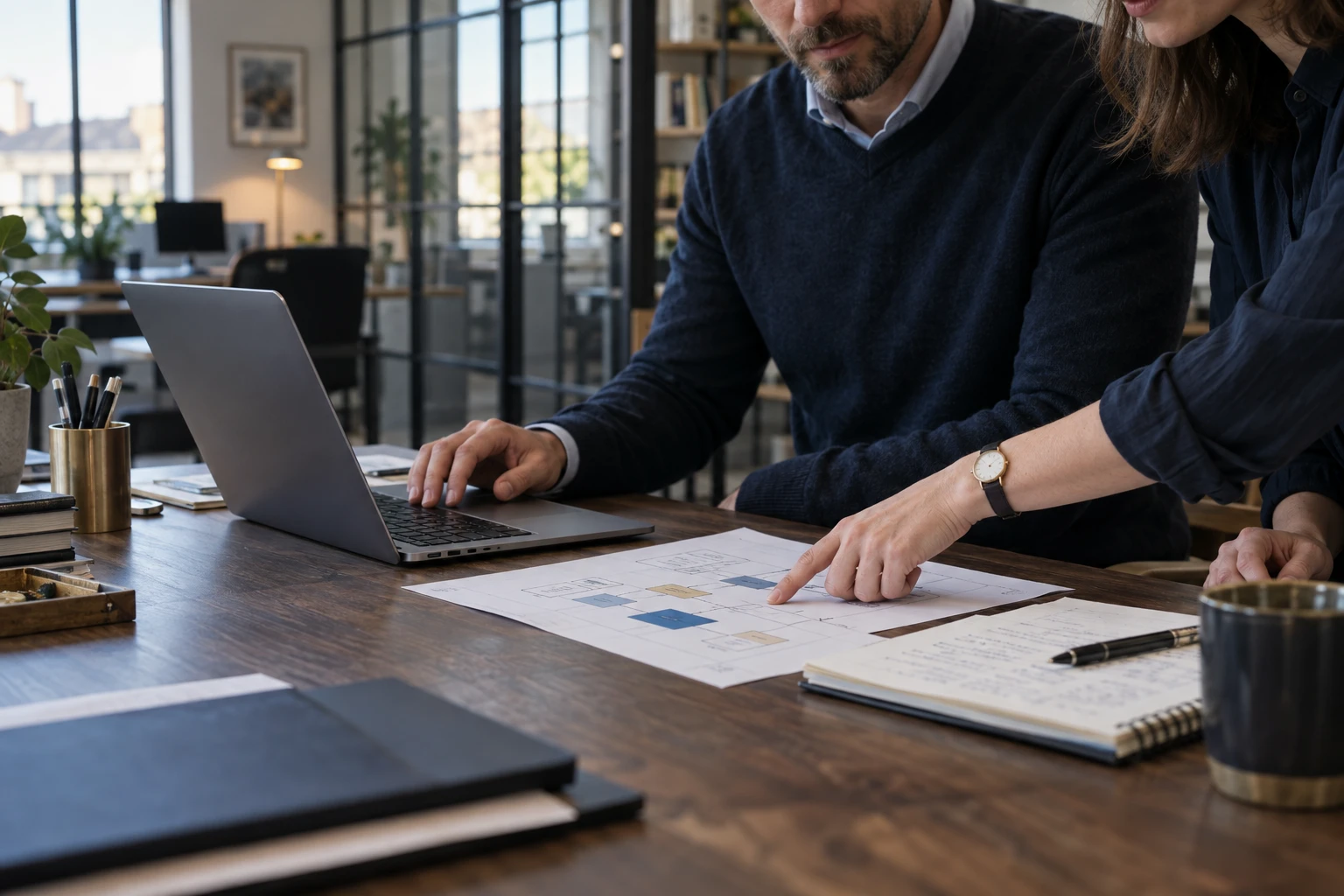 Colleagues working through a process at a desk.